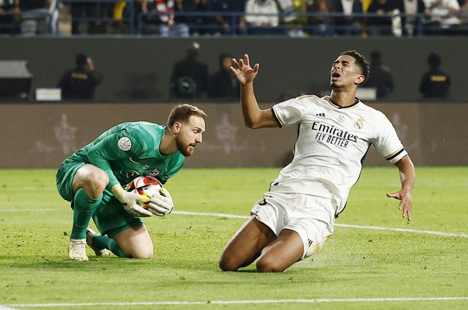 Jan Oblak je že znal ukrotiti Juda Bellinghama, ki ga na petih tekmah še ni premagal. FOTO: Juan Medina/Reuters