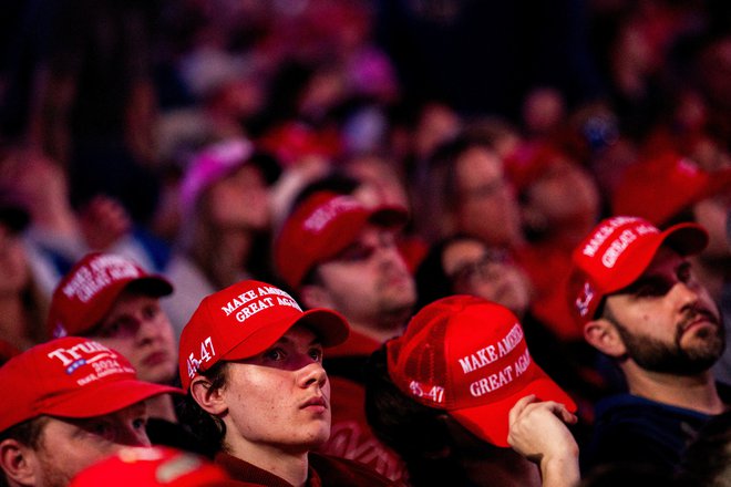 Ko so podporniki čakali na Donalda Trumpa, so iz topa letele med občinstvo majice z napisom Make America Great Again. FOTO: Emily Elconin/Reuters