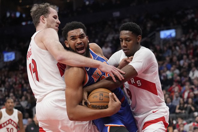 Center košarkarjev New Yorka Karl-Anthony Towns (v sredini)) se je v Torontu moral izvleči tudi iz trših prijemov tekmecev. FOTO: John E. Sokolowski/Usa Today Sports Via Reuters Con