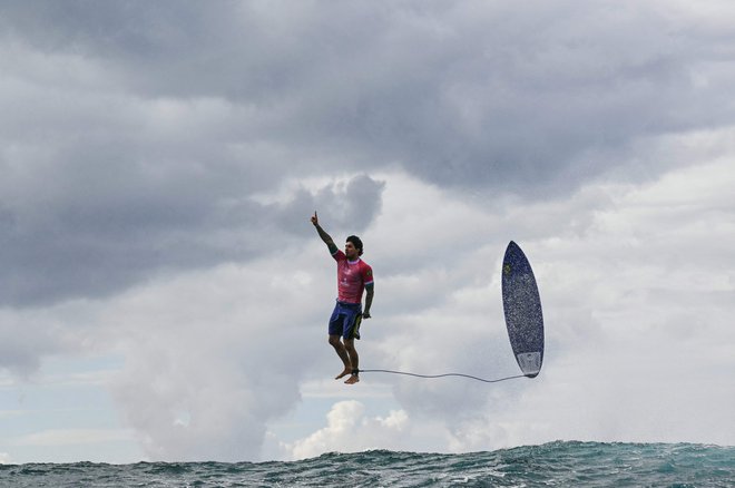 Brazilski deskar Gabriel Medina po tem, ko je v 5. vožnji 3. kroga moškega deskanja uspešno odpeljal val na OI na francoskem polinezijskem otoku TahitI. Foto: Jerome Brouillet/Afp